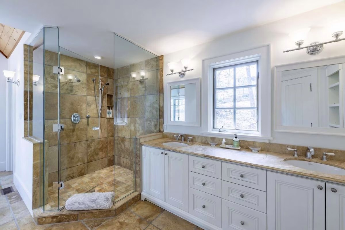 Primary ensuite with a glass shower and double vanity